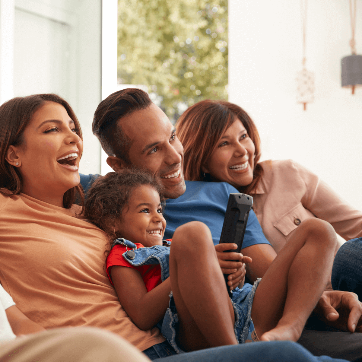 Family sitting on couch with remote